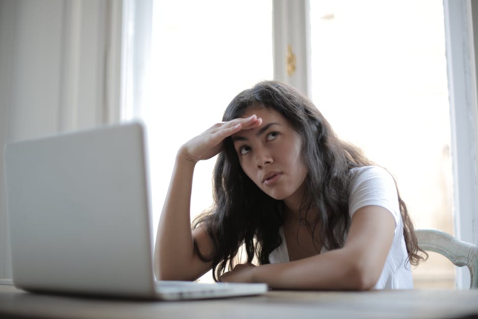 woman stressed sitting a laptop